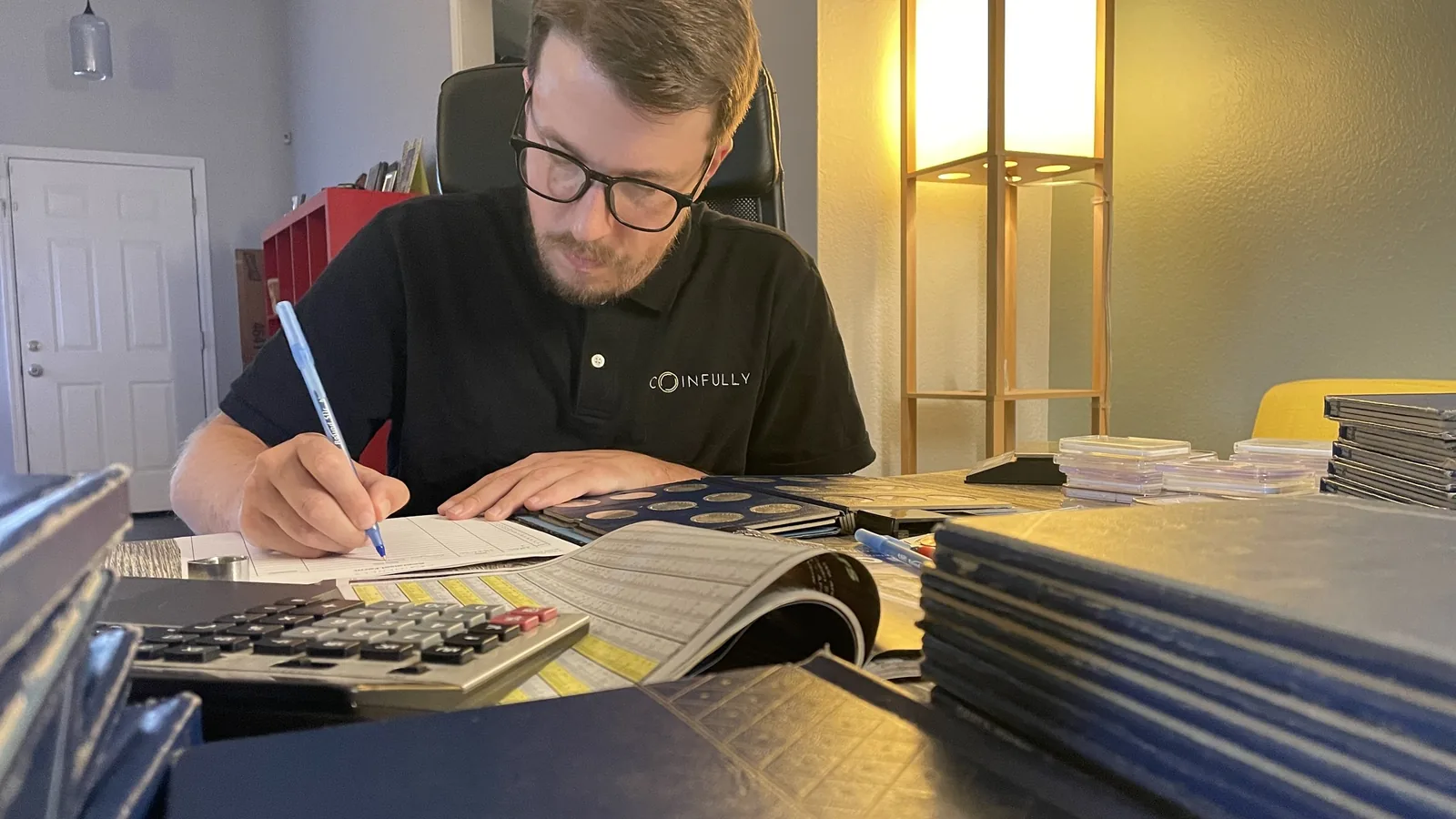 Wyatt McDonald examining a rare coin during an appraisal